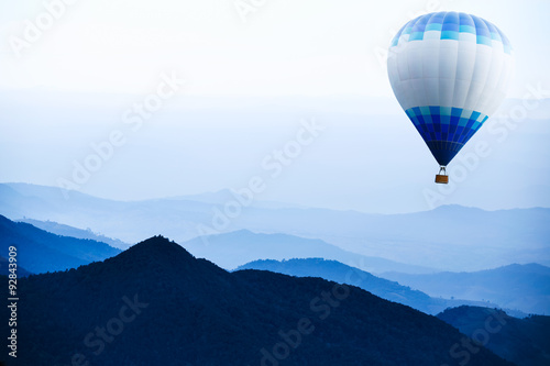 Hot air balloon over mountain 