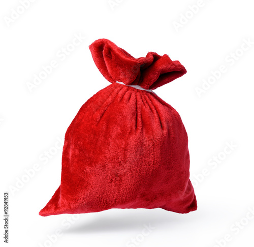Flying Santa Claus red bag full, on white background. File contains a path to isolation. 