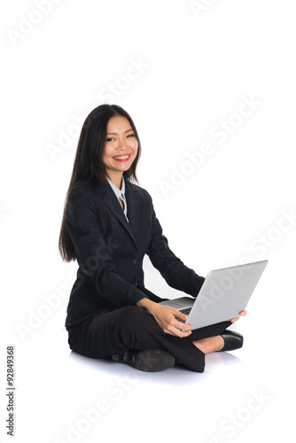 asian chinese female sitting and using laptop © wong yu liang