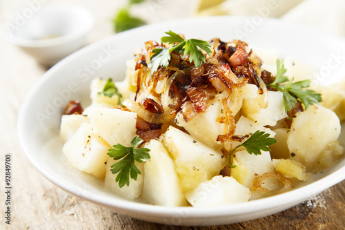 Potato salad with apples, fried onion and ham