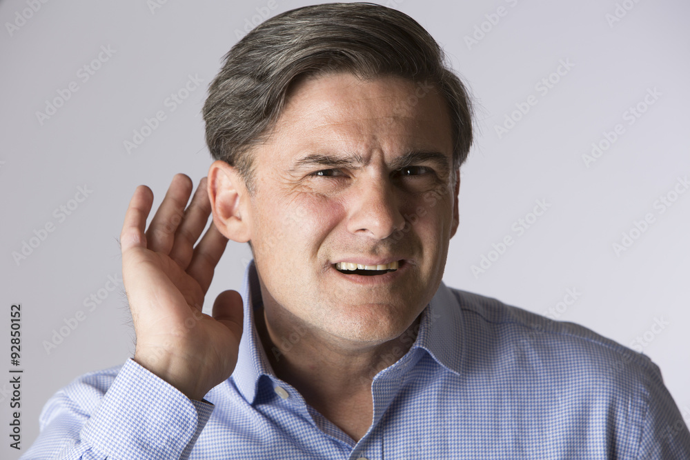 Studio Shot Of Man Suffering From Deafness Studio Shot Of Man Suffering From Deafness