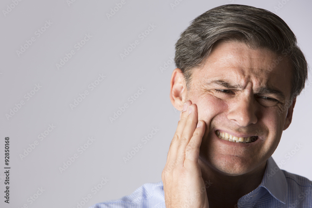 Studio Portrait Of Man Suffering With Toothache Studio Portrait Of Man Suffering With Toothache