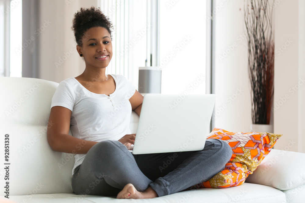 African American student girl using a laptop computer - black pe African American student girl using a laptop computer - black pe