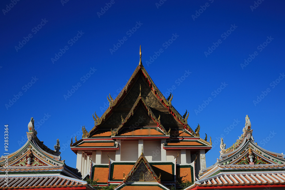 Rooftop of Buiddhist temple in the blue sky