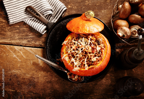 Tasty autumn stuffed pumpkin with mushrooms photo