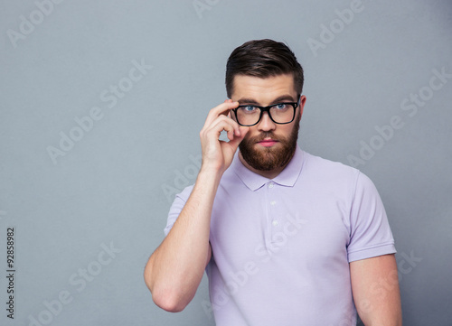 Serious man in glasses looking at camera