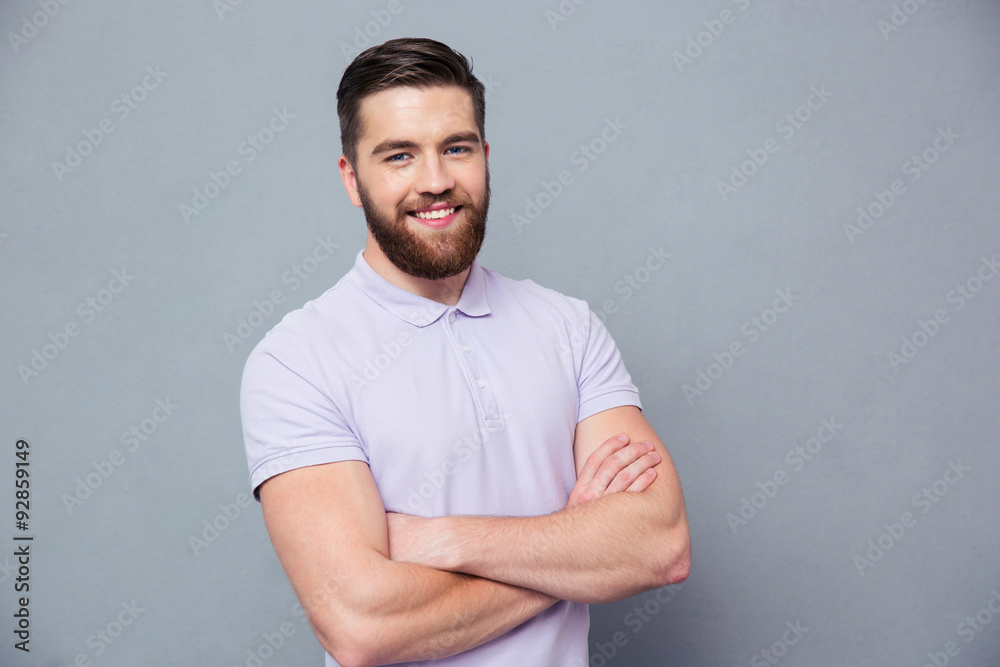 Happy man standing with arms folded Happy man standing with arms folded