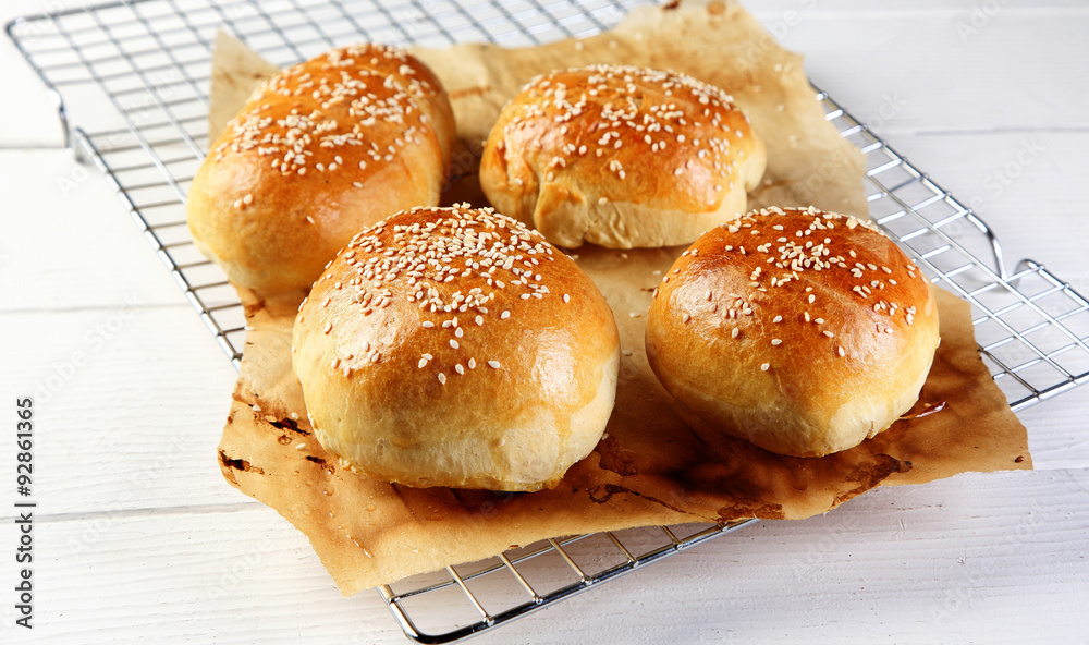 Delicious Burger Buns on Wire Rack with Paper Delicious Burger Buns on Wire Rack with Paper