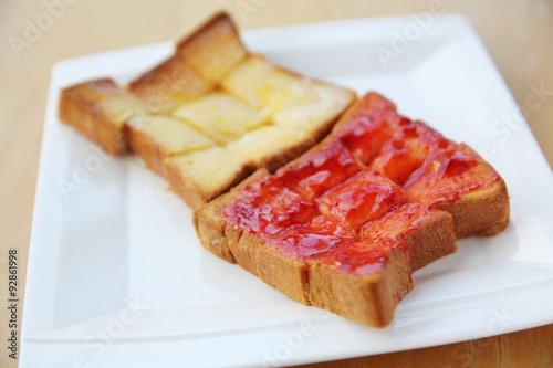 grilled bread with starwberry jam and milk