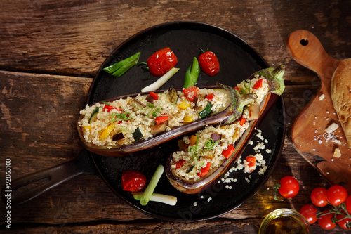 Top down view of a stuffed aubergine with couscous or quinoa