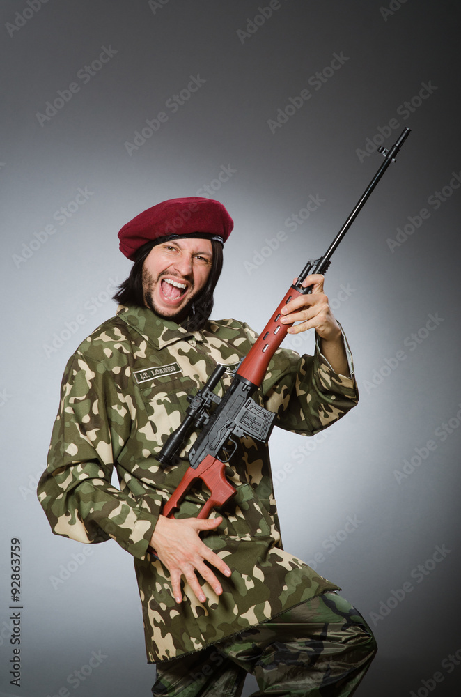 Soldier with handgun against gray Soldier with handgun against gray