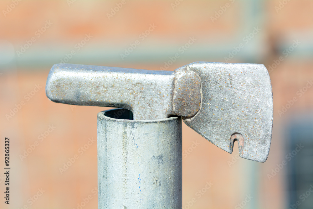 Roofers tiling hammer in end of scaffolding pole Roofers tiling hammer in end of scaffolding pole