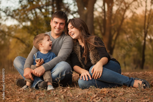 Portrait of happy family in autumn forest