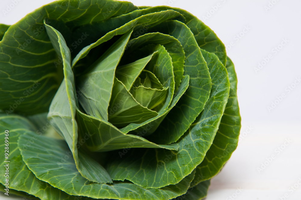 fresh green cabbage plant on a white crate fresh green cabbage plant on a white crate