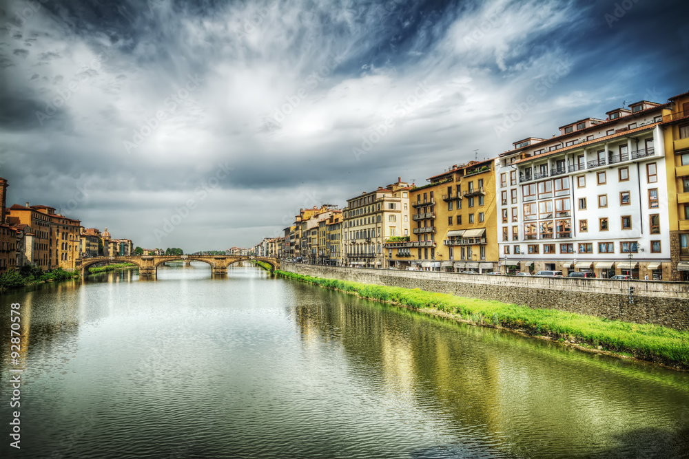 Arno river under a dramatic sky in Florence