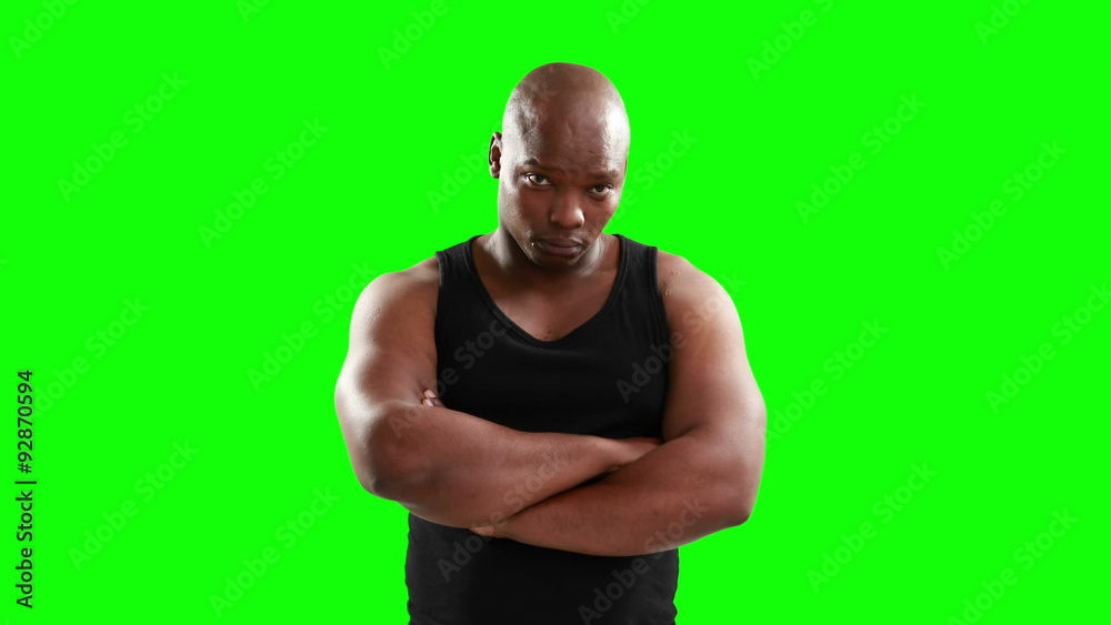 Muscular man with arms crossed looking at camera Muscular man with arms crossed looking at camera