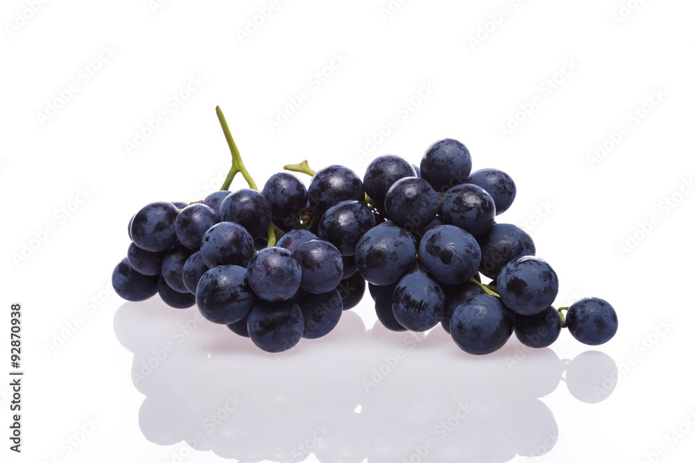 Fresh grape cluster on white with water drops