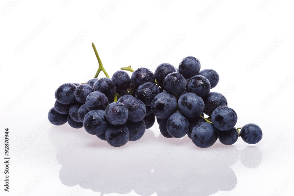 Fresh grape cluster on white with water drops Fresh grape cluster on white with water drops