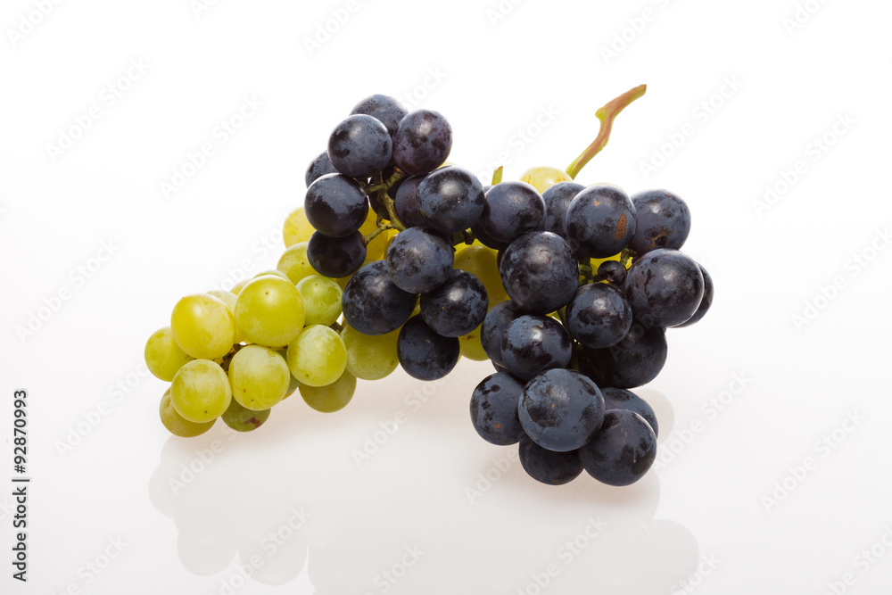 Fresh grape cluster on white with water drops