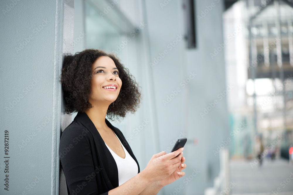 African american business woman smiling with mobile phone African american business woman smiling with mobile phone