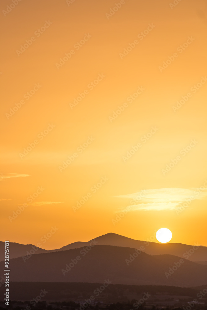 Scenic view of a beautiful rich orange sunset over the mountains Scenic view of a beautiful rich orange sunset over the mountains