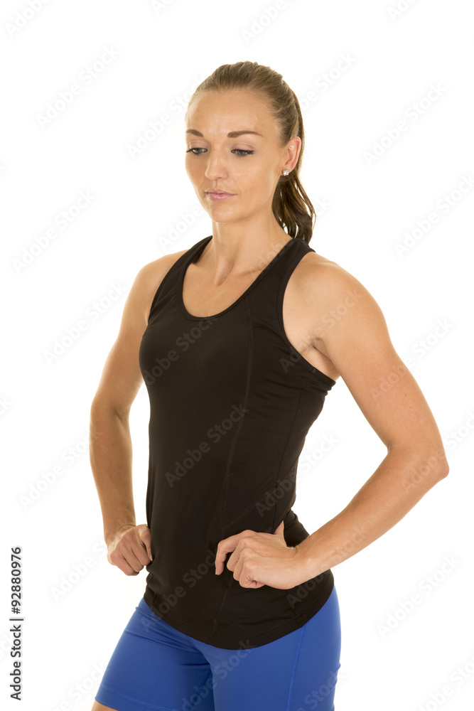 woman fitness black tank top hands hips look down woman fitness black tank top hands hips look down