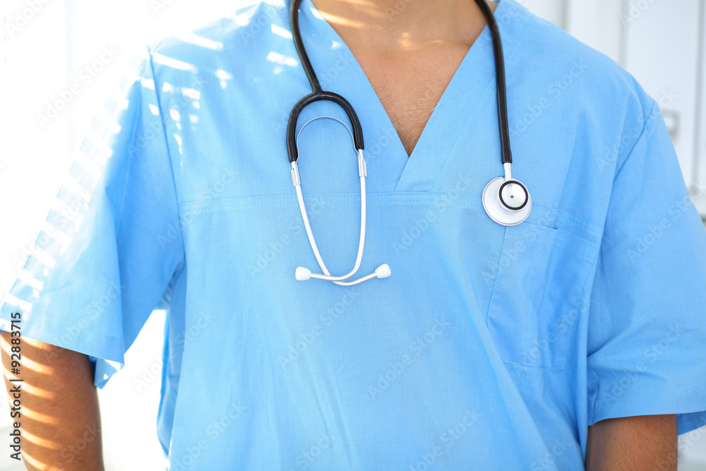 Portrait of unknown male surgeon doctor holding his stethoscope Portrait of unknown male surgeon doctor holding his stethoscope