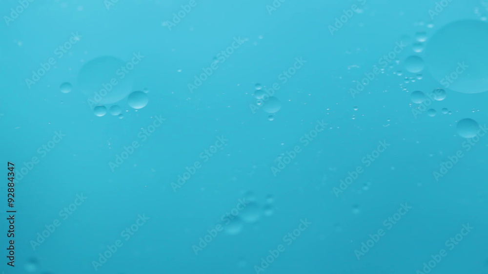 Abstract close-up of floating oil drops on water surface Abstract close-up of floating oil drops on water surface