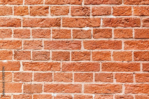 Old wall of broken red brick