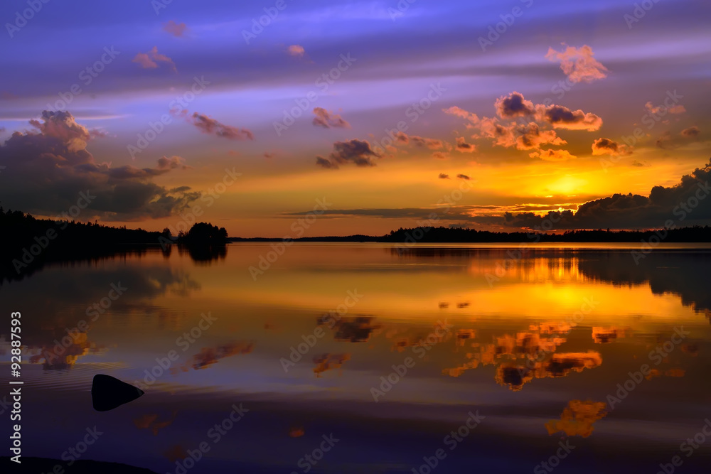 Picturesque mirror  sunset. Lake Pongoma, North Karelia, Russia