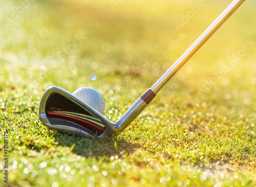 Close-up of golf ball with club