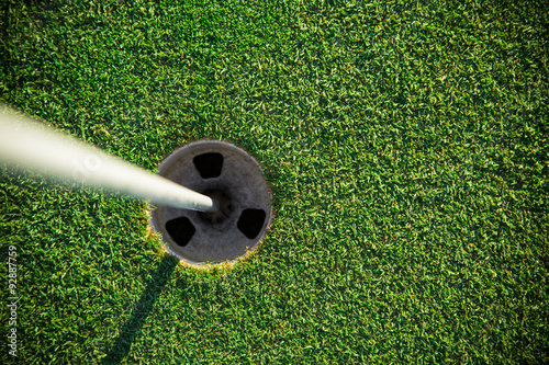 Close-up of golf hole.