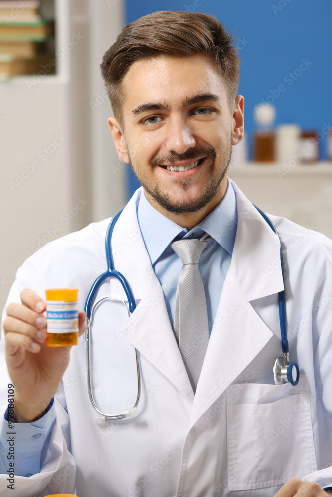 Doctor holding bottle with medical cannabis close up Doctor holding bottle with medical cannabis close up