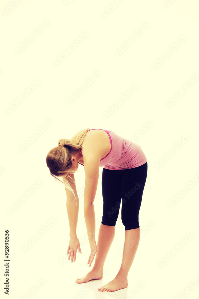 Young woman in bent yoga pose. Young woman in bent yoga pose.