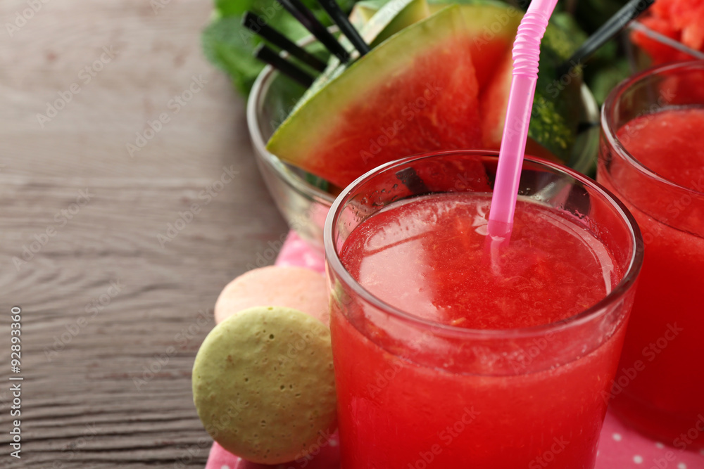 Cold watermelon drinks in glasses, on wooden table background Cold watermelon drinks in glasses, on wooden table background