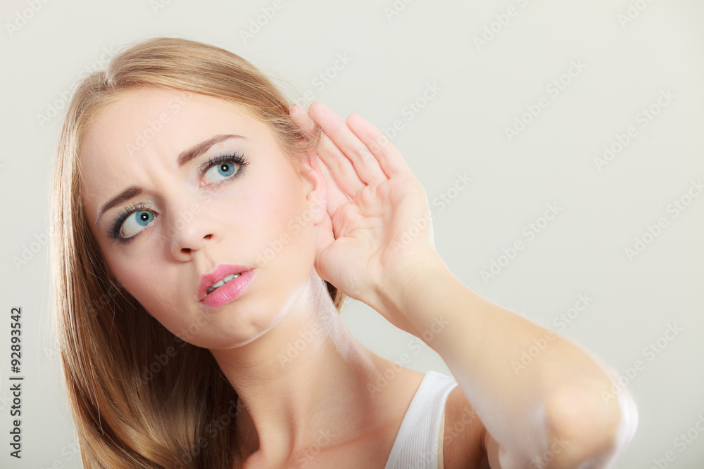 Woman with hand behind ear spying Woman with hand behind ear spying