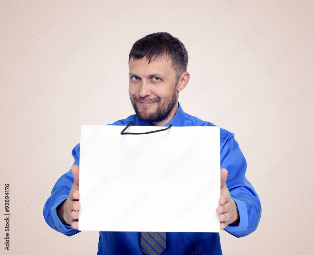 Bearded smiling man gives a gift