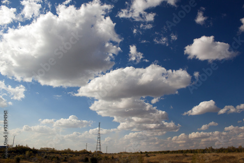 Blue sky with big clouds far to field