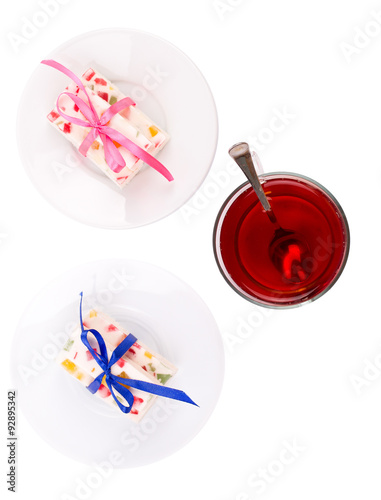 Tea and fruit candy on a white background