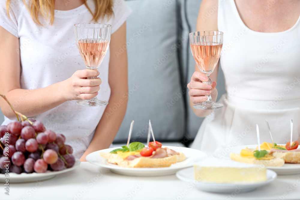 Friends hands with glasses of wine and snacks , close up Friends hands with glasses of wine and snacks , close up