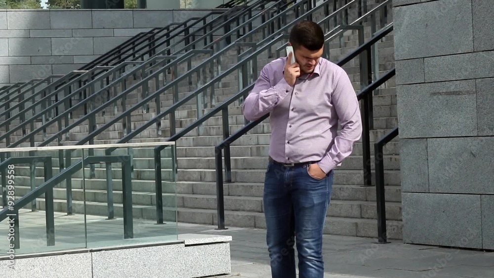 Business man is talking on the phone near his job Business man is talking on the phone near his job