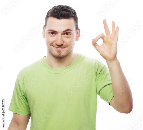 young casual man showing the victory gesture