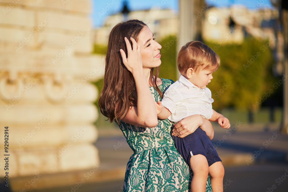 Fototapeta premium Beautiful young mother with her adorable in Paris, France