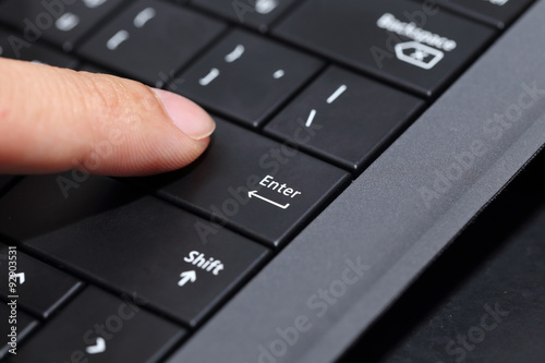 background of finger pushing on the enter button