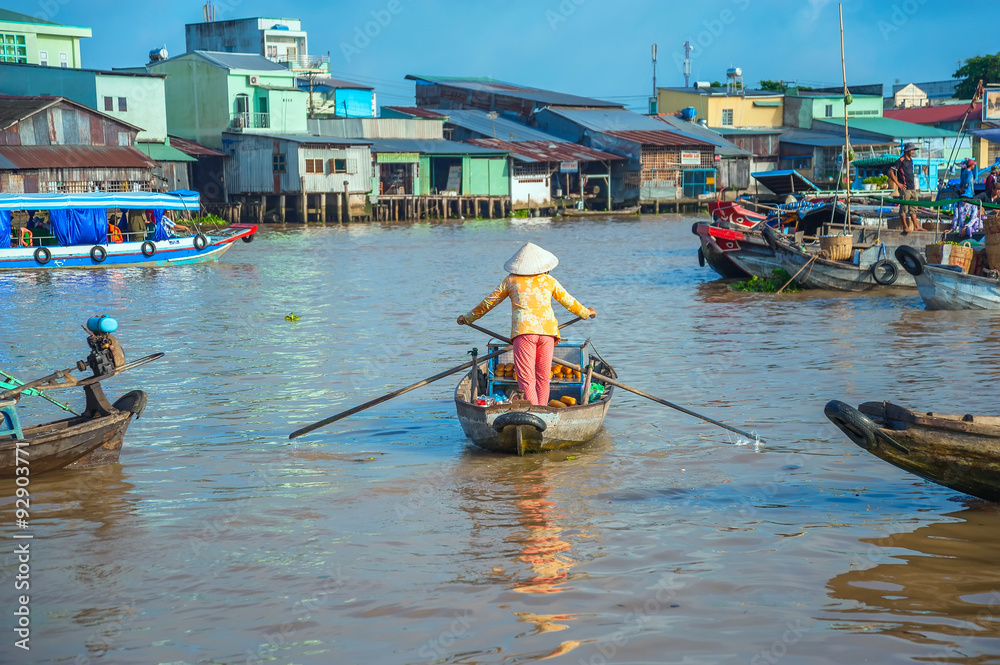 Woman rowing boat on floating market