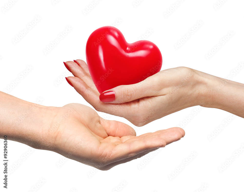 Red heart in woman hand and man hand, isolated on white