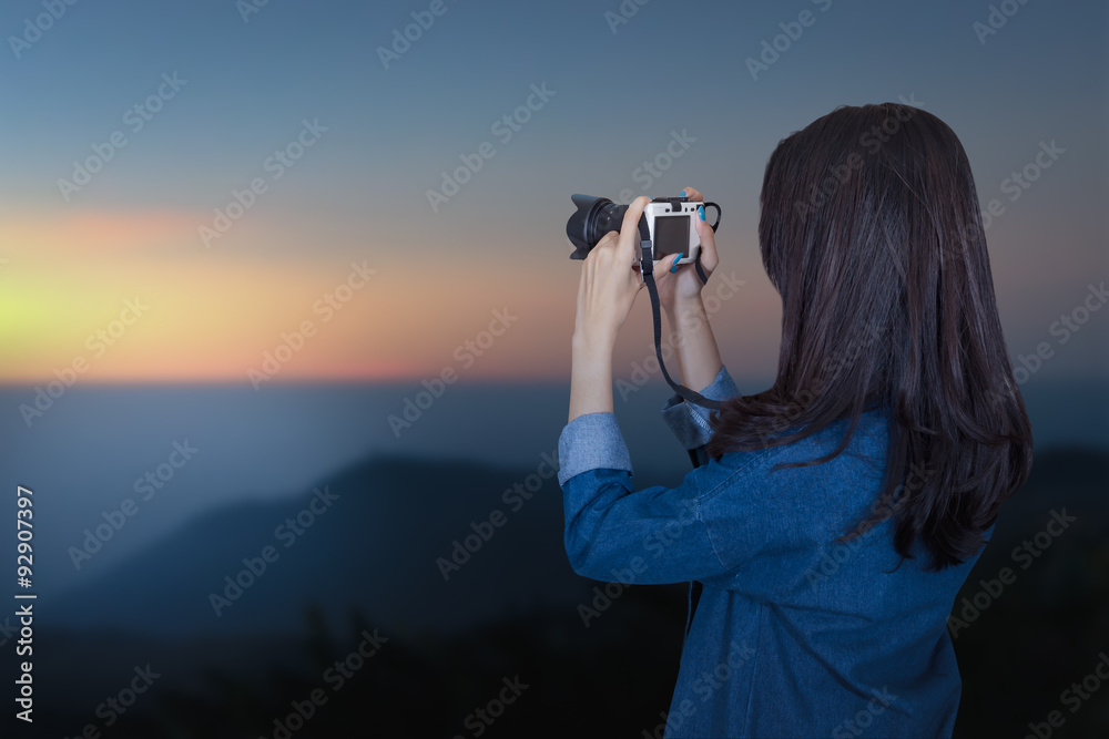 woman traveler wearing blue dress as photographer, take photo wi