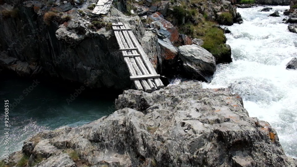With fear to move across the bridge over mountain river in Altai
With fear to move across the bridge over mountain river in Altai