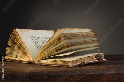 Old open book on a table.