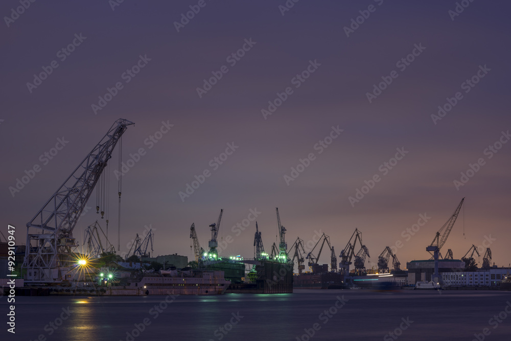 Night view on a cranes in the dock, near Neva river.

